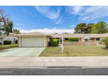 Charming single-story home with a two-car garage and well-maintained front yard at 10137 W Forrester Dr, Sun City, AZ 85351