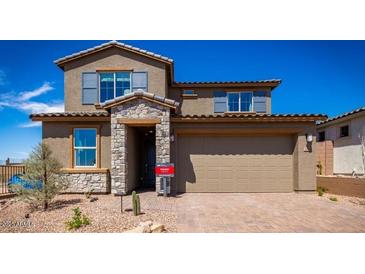 Charming two-story home featuring stone accents, a spacious two-car garage, and beautiful desert landscaping at 12239 W Caraveo Pl, Peoria, AZ 85383