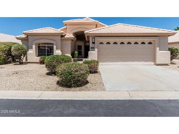 Charming single story home with a two car garage and a well kept xeriscaped front yard at 14672 W Whitton Ave, Goodyear, AZ 85395