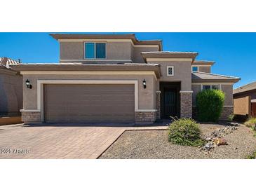 Charming two-story home features a paver driveway, tan stucco, and a two-car garage at 2321 W Brookhart Way, Phoenix, AZ 85085