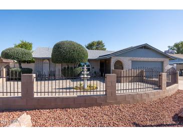 Charming single-story home featuring a private, enclosed front yard with a fountain at 3833 W Phelps Rd, Phoenix, AZ 85053