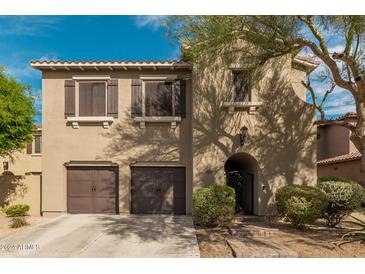 Charming two-story home featuring a tile roof, dark brown shutters, and arched front door at 3964 E Hummingbird Ln, Phoenix, AZ 85050