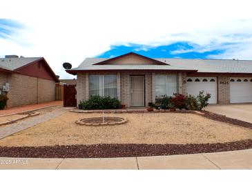 Charming single-story home with well-kept front yard and inviting curb appeal in a well-established neighborhood at 9625 W Mountain View Rd # B, Peoria, AZ 85345