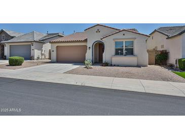 Charming single-story home with a well-maintained front yard and neutral color palette at 10739 W Sierra Pinta Dr, Peoria, AZ 85373