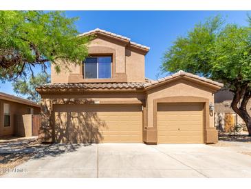 Charming two-story home featuring a tile roof and a spacious two-car garage at 14436 N 162Nd Ln, Surprise, AZ 85379