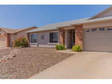 Charming single-story home with a two-car garage, low-maintenance landscaping, and inviting curb appeal at 2056 E San Tan Ct, Gilbert, AZ 85296