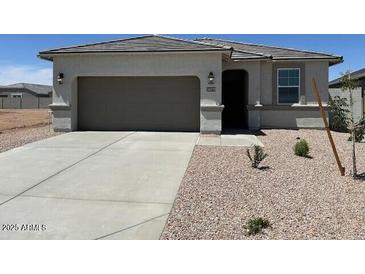 Charming single-story home with neutral stucco, concrete driveway, and well-maintained desert landscaping at 38070 W Frascati Ave, Maricopa, AZ 85138