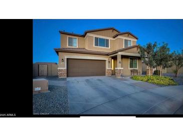 Charming two-story home featuring a two-car garage and well-maintained front yard at 5306 N 188Th Ln, Litchfield Park, AZ 85340