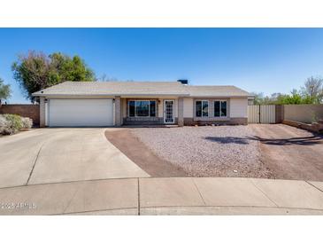 Charming single-story home with a two-car garage and low maintenance landscaping at 7210 W Caron Dr, Peoria, AZ 85345