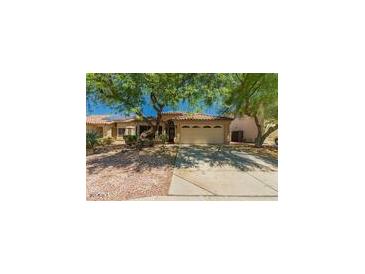 Charming single-story home with a two-car garage and mature trees in a well-maintained neighborhood at 15460 W Mescal W St, Surprise, AZ 85379