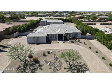Stunning estate features circular driveway, mature landscaping, and detached garage at 16645 W Papago St, Goodyear, AZ 85338