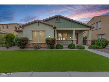Charming single-Gathering home boasting mature landscaping, a cozy porch, and vibrant curb appeal at 3819 N Springfield St, Buckeye, AZ 85396