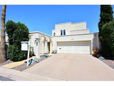 Charming stucco home featuring a two-car garage and decorative rock landscaping at 4317 N 70Th St, Scottsdale, AZ 85251