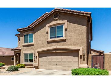 Two-story home showcasing a neutral stucco exterior, a tiled roof, and an attached two-car garage at 5110 E Mark Ln, Cave Creek, AZ 85331