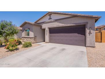 Charming single-story home featuring a two-car garage, desert landscaping, and neutral earth tone colors at 948 E Wiley Way, Casa Grande, AZ 85122