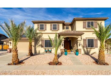 Two-story home with desert landscaping, covered entry, decorative shutters, and a charming walkway at 11737 N 143Rd Dr, Surprise, AZ 85379