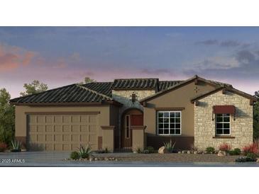 Charming single-story home with a two-car garage and stone accents around the window and doorway at 17836 W Pasadena Ave, Litchfield Park, AZ 85340