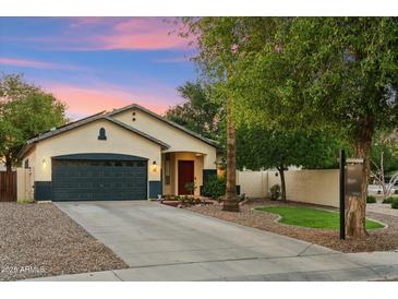 Charming single-story home with a well-maintained yard, two car garage, and inviting entryway at 1924 S Rome St, Gilbert, AZ 85295