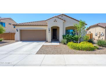 Charming single story home with a desert landscape and a two car garage at 25951 W Piute Ave, Buckeye, AZ 85396