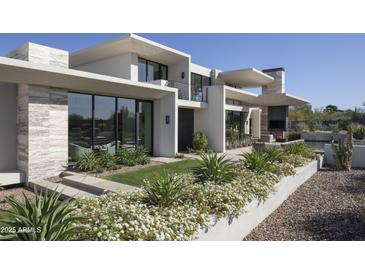 Stunning modern home showcasing meticulous landscaping and sleek architectural design elements at 4451 E Joshua Tree Ln, Paradise Valley, AZ 85253
