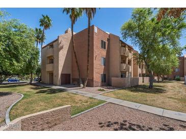 Condo exterior showing balconies, desert landscaping, and mature trees at 540 N May -- # 2148, Mesa, AZ 85201