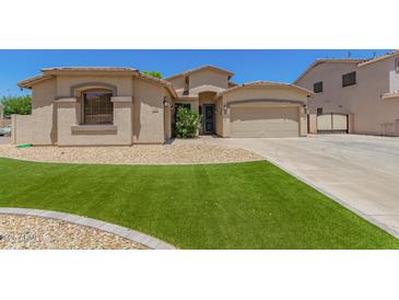 Charming home featuring a well-manicured lawn and a two-car garage, offering curb appeal and convenience at 7008 W Southgate Ave, Phoenix, AZ 85043