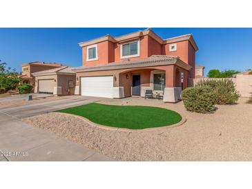 Charming two-story home with artificial turf, desert landscaping, and a two-car garage at 7227 S 13Th Way, Phoenix, AZ 85042