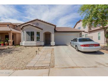 Charming single-story home with a low-maintenance desert landscape and a two-car garage at 9124 W Williams St, Tolleson, AZ 85353