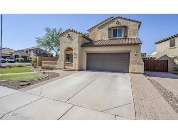 Inviting two-story home featuring a two-car garage, tile roof, and low-maintenance landscaping for enhanced curb appeal at 10925 E Toluca Ave, Mesa, AZ 85212
