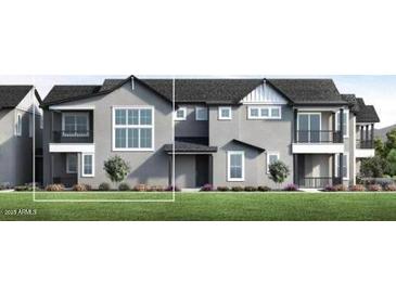 Modern townhome with a sleek gray facade, multiple windows, and a well-manicured lawn at 11300 N Casa Dega Dr # 1005, Surprise, AZ 85388