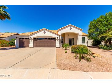 Charming single-story home featuring a three-car garage, desert landscaping, and a well-maintained front yard at 1710 S Aaron --, Mesa, AZ 85209