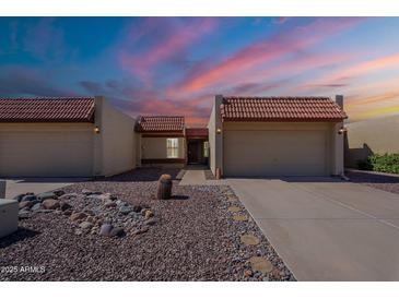 Charming home featuring desert landscaping, a tile roof, and a two-car garage, all under a vivid sky at 2527 E Villa Theresa Dr, Phoenix, AZ 85032