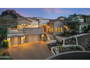 Stunning two-story stone home with a three-car garage, manicured landscaping, and elegant architectural details at 4366 S Avenida De Angeles --, Gold Canyon, AZ 85118