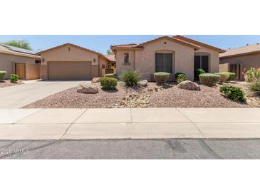 Charming single-story home featuring a well-maintained front yard with desert landscaping at 5919 W Straight Arrow Ln, Phoenix, AZ 85083