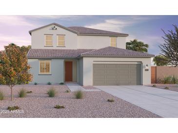 Charming two-story home with a two car garage, landscaped front yard, and covered entryway at 12647 W Parkway Ln, Avondale, AZ 85323