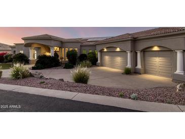 Stunning home exterior featuring a manicured landscape, a tiled roof, and a two-car garage at 402 E Windmere Dr, Phoenix, AZ 85048