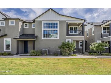 Charming two-story home with a well-manicured lawn and inviting front porch at 11300 N Casa Dega Dr # 1019, Surprise, AZ 85388