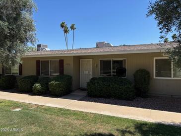 Charming single-story home with well-maintained landscaping and covered entry at 13603 N 111Th Ave, Sun City, AZ 85351