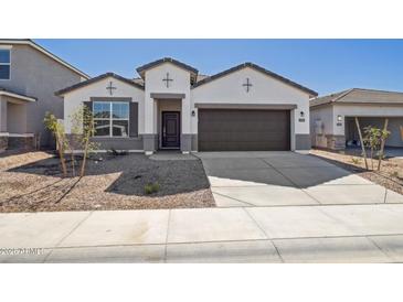 Charming single-Gathering home with a well-manicured front yard and a two-car garage, showcasing modern architecture at 17778 W Turquoise Ave, Waddell, AZ 85355