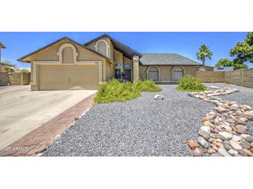 Charming single-Gathering home featuring a well-maintained yard and a two-car garage, offering curb appeal at 5424 E Florian Ave, Mesa, AZ 85206