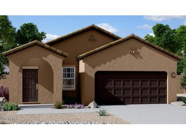 Lovely tan stucco home with dark brown garage door and arched entryway at 5782 E Orion Rd, Florence, AZ 85132