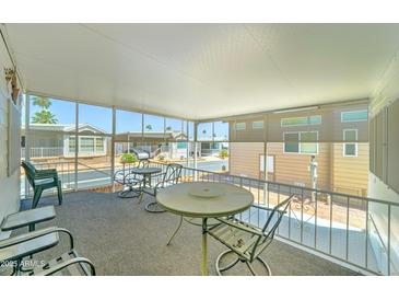 Relaxing screened patio with outdoor furniture and a view of the community at 111 S Greenfield Rd # 467, Mesa, AZ 85206