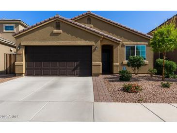 Charming single-story home with a desert-landscaped front yard and two-car garage at 2023 W Yellowbird Ln, Phoenix, AZ 85085