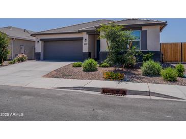 Charming single-story home showcasing desert landscaping and a two-car garage at 37008 N Aleutian Dr, San Tan Valley, AZ 85143