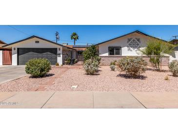 Charming single-story home featuring a low-maintenance yard and decorative accents over the brickwork at 554 N Sunset Dr, Chandler, AZ 85225