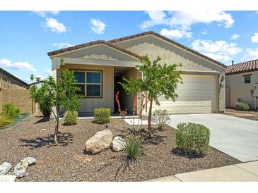Inviting single-story home featuring a two-car garage and charming desert landscaping at 18032 W Muirwood Dr, Goodyear, AZ 85338