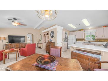 Inviting living room featuring neutral walls, modern ceiling fan, and built-in shelving at 2400 E Baseline Ave # 197, Apache Junction, AZ 85119