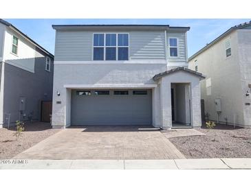 Charming two-story home features a two-car garage and nicely landscaped front yard at 2482 W Rowel Rd, Phoenix, AZ 85085