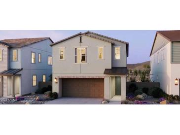 Charming two-story home with a neutral color palette, attached garage, and well-maintained landscaping at 2482 W Rowel Rd, Phoenix, AZ 85085