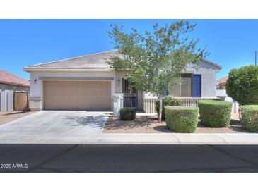 Charming home featuring a low-maintenance desert landscape, tile roof, and a spacious two-car garage at 41004 W Crane Dr, Maricopa, AZ 85138